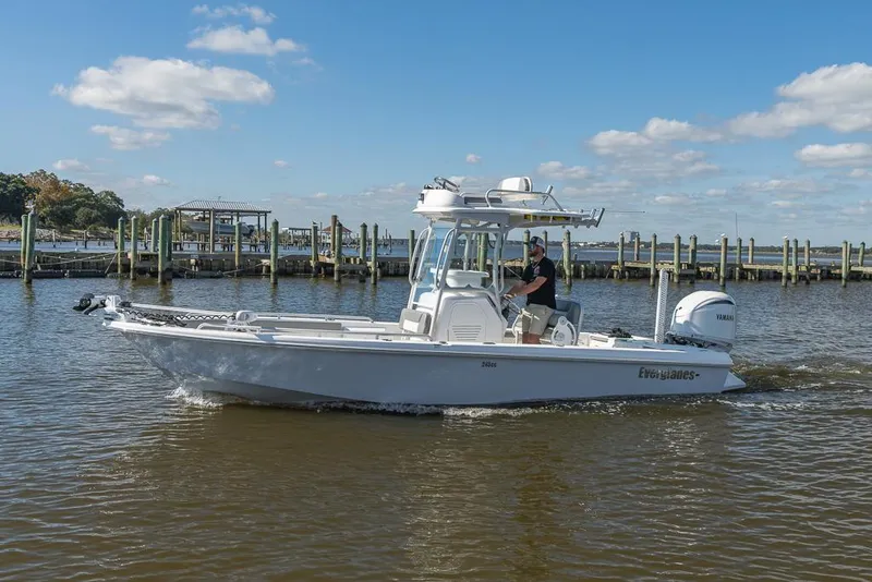 Slide: The Image of 2023 Everglades 243cc Sport Station boat cruising on a sunny day. - 10
