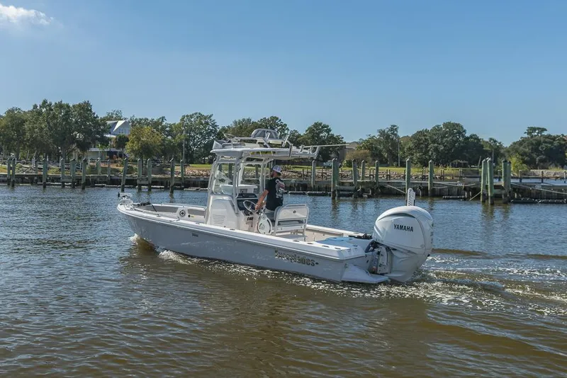 Slide: The Image of 2023 Everglades 243cc Sport Station boat cruising on a sunny day. - 13