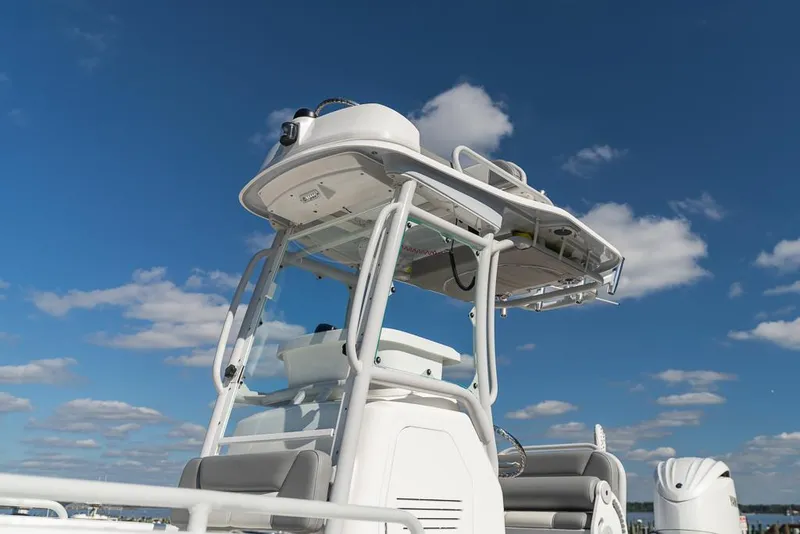 Slide: The Image of 2023 Everglades 243cc Sport Station boat under a clear blue sky. - 23