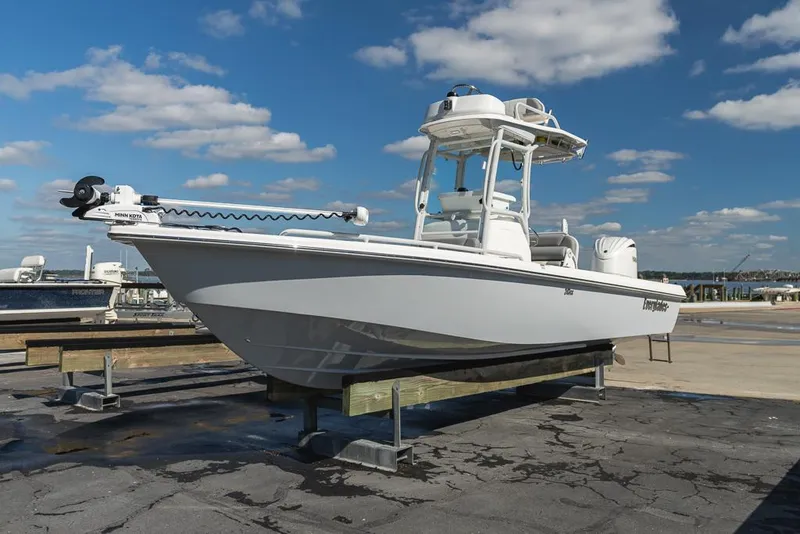 Slide: The Image of 2023 Everglades 243cc Sport Station boat on display under a clear blue sky. - 24