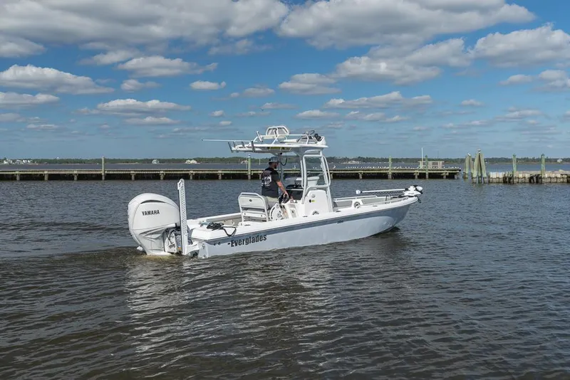 Slide: The Image of 2023 Everglades 243cc Sport Station boat cruising on a sunny day. - 25
