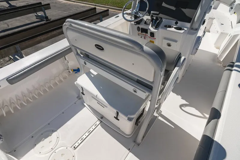 Slide: The Image of 2023 Everglades 243cc Sport Station boat interior with seating and steering console. - 35