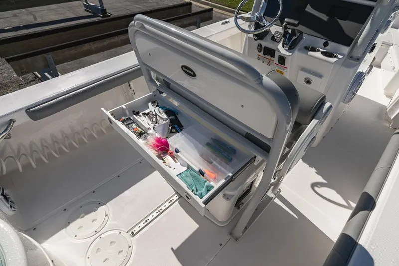 Slide: The Image of 2023 Everglades 243cc Sport Station boat with open storage compartment. - 36
