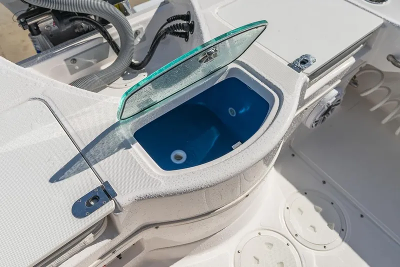Slide: The Image of 2023 Everglades 243cc Sport Station boat with open storage compartment. - 38