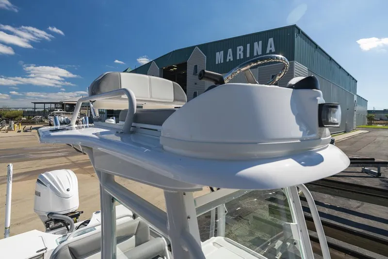 Slide: The Image of 2023 Everglades 243cc Sport Station boat at marina, clear sky background. - 47
