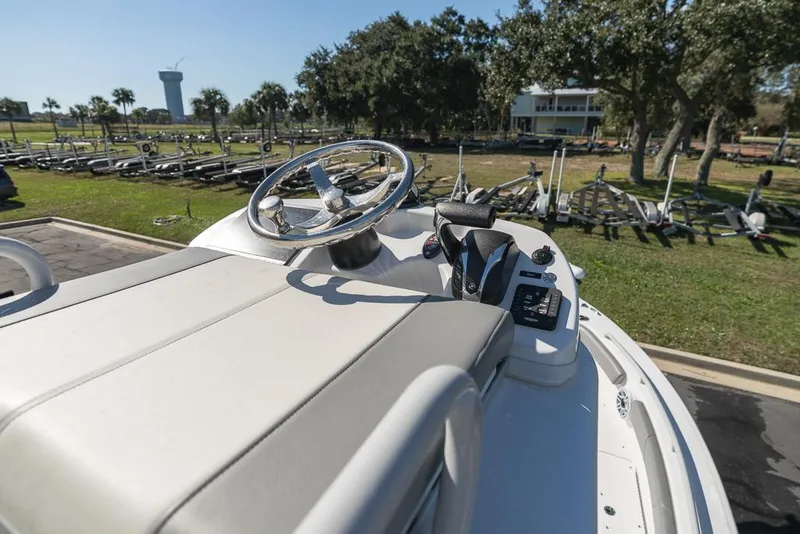 Slide: The Image of 2023 Everglades 243cc Sport Station boat helm with steering wheel and controls. - 49