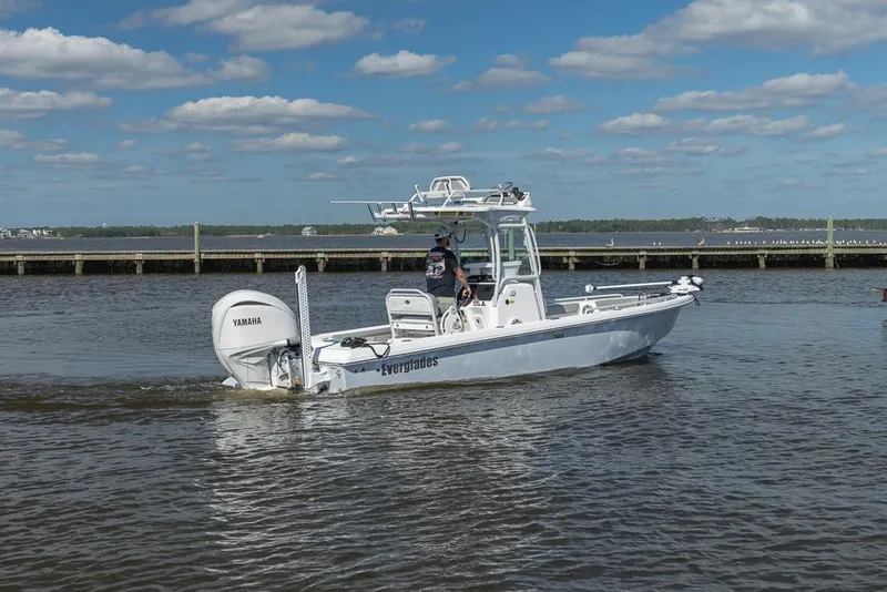 Slide: The Image of 2023 Everglades 243cc Sport Station boat cruising on a sunny day. - 6