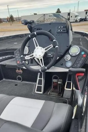 Slide: The Image of 2013 Ranger 520C boat cockpit with steering wheel and control panel. - 2