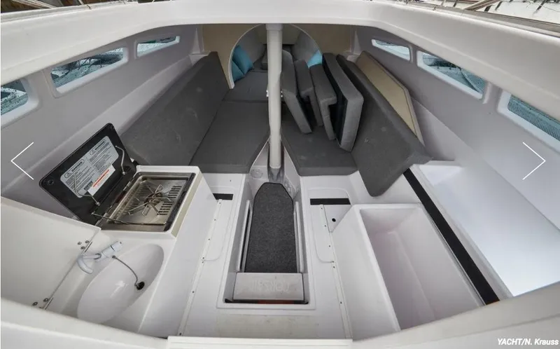 Slide: The Image of Interior of 2025 Corsair 760 sailboat with compact kitchen and seating area. - 6