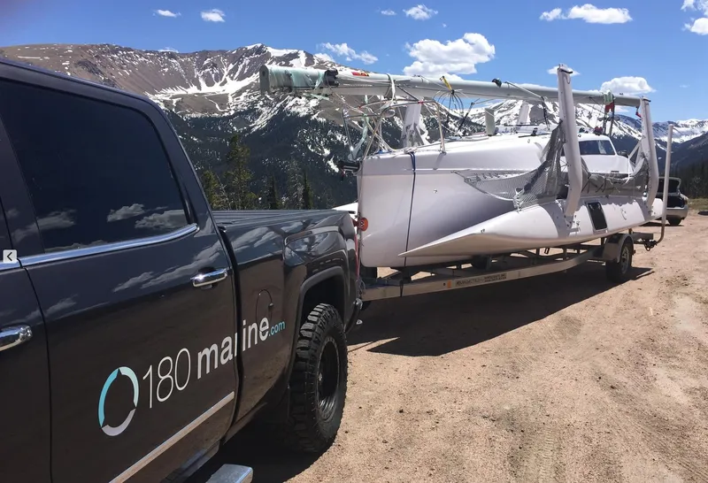 Slide: The Image of Truck towing a Corsair 760 sailboat through scenic mountain landscape, 2025 model. - 10