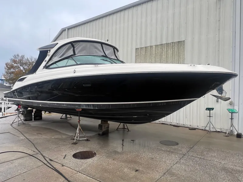 Slide: The Image of 2018 Sea Ray SLX 350 boat on stands outside a warehouse. - 0