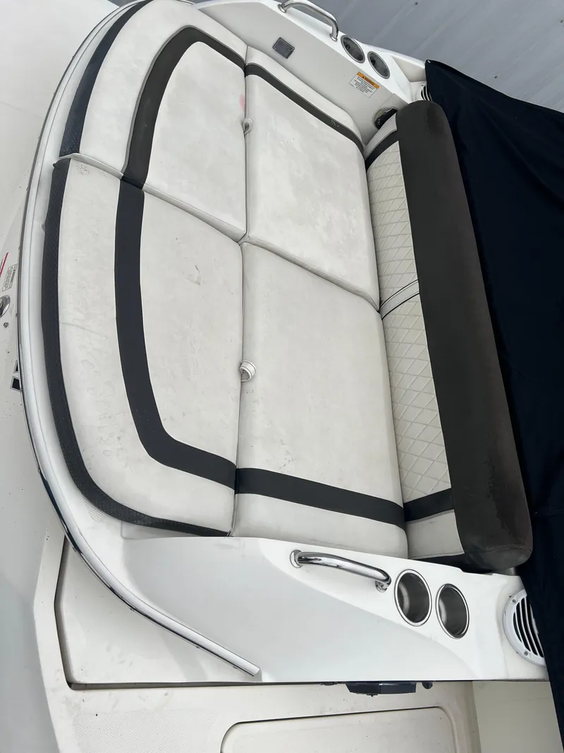 Slide: The Image of 2018 Sea Ray SLX 350 boat seating area with cup holders and black accents. - 11