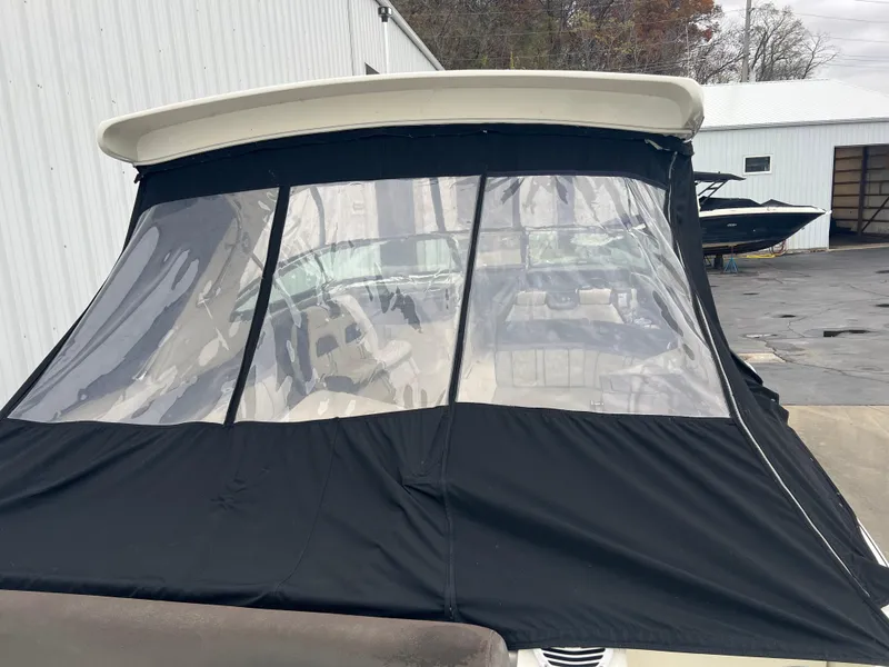 Slide: The Image of 2018 Sea Ray SLX 350 with black canvas cover in a marina setting. - 12