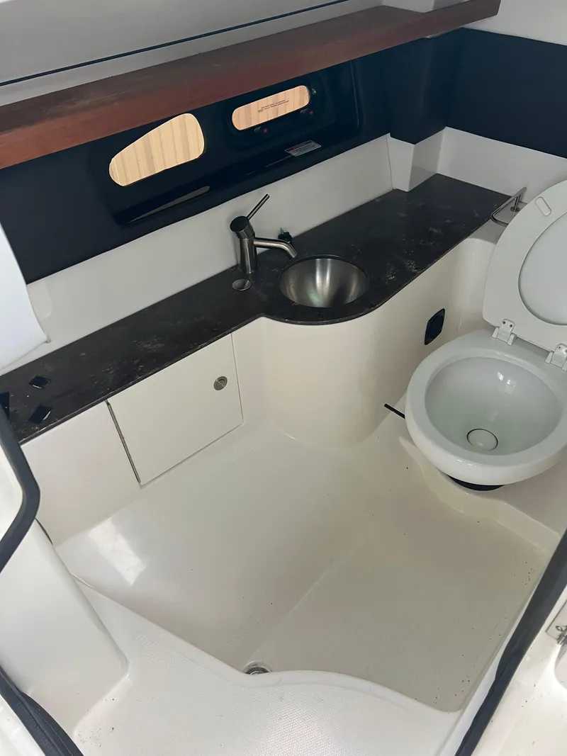Slide: The Image of 2018 Sea Ray SLX 350 boat bathroom with sink and toilet. - 18
