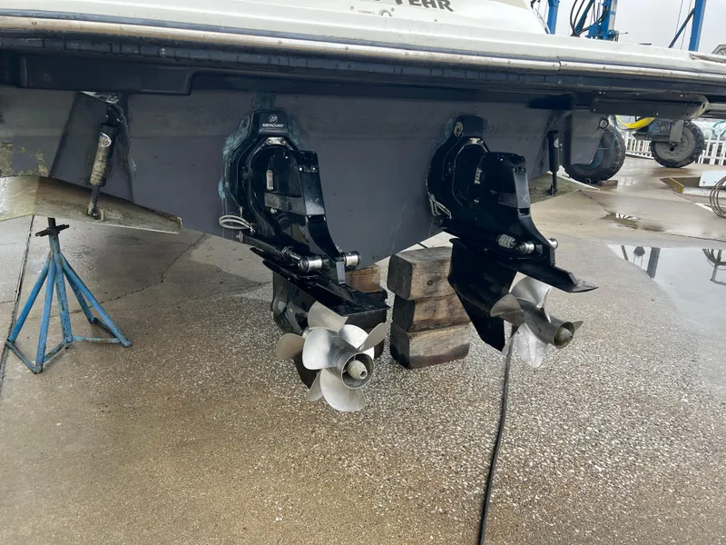 Slide: The Image of 2018 Sea Ray SLX 350 boat with dual propellers on a stand. - 19