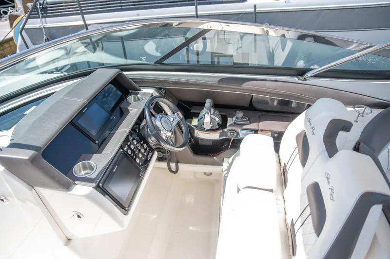 Slide: The Image of 2018 Sea Ray SLX 350 cockpit with modern controls and luxurious seating. - 20