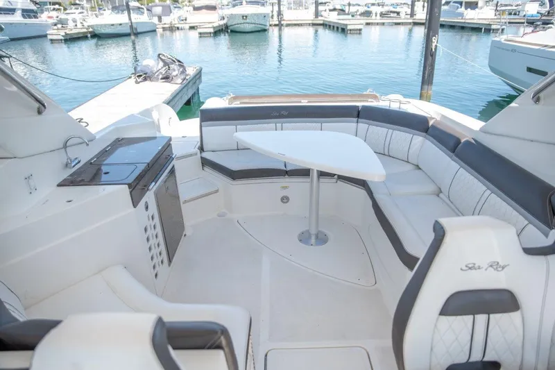Slide: The Image of Luxurious 2018 Sea Ray SLX 350 boat interior with spacious seating and table at marina. - 21