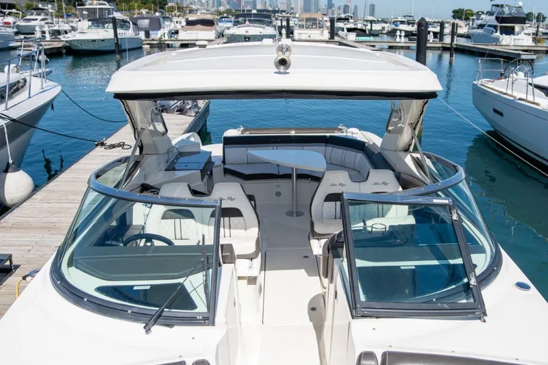 Slide: The Image of 2018 Sea Ray SLX 350 boat docked at marina, featuring spacious seating and sleek design. - 23
