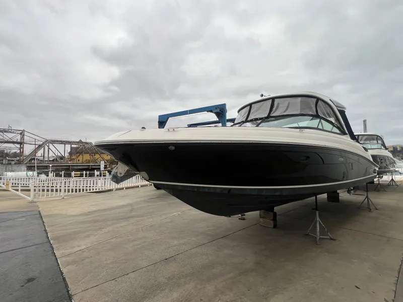 Slide: The Image of 2018 Sea Ray SLX 350 boat on display, overcast sky, marina background. - 4