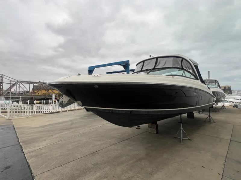 Slide: The Image of 2018 Sea Ray SLX 350 boat on dry dock under cloudy skies. - 5