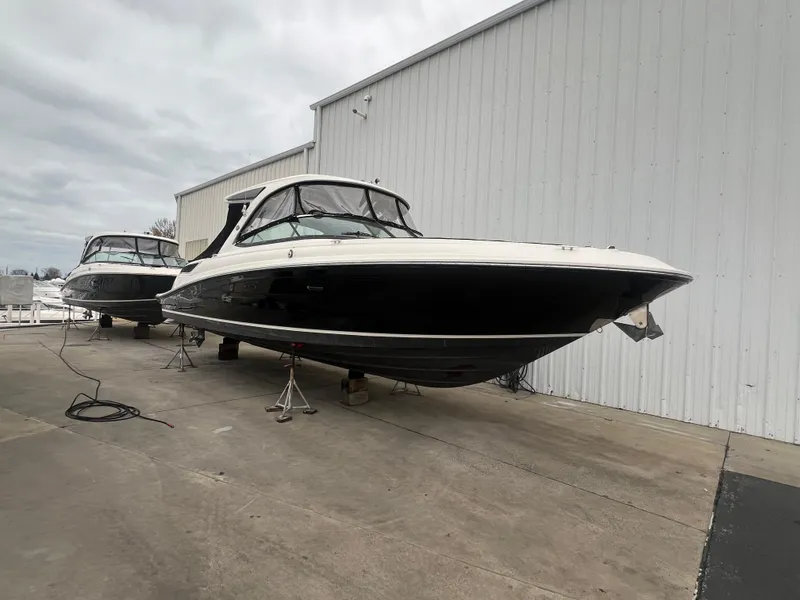 Slide: The Image of 2018 Sea Ray SLX 350 boats on stands outside a warehouse. - 6