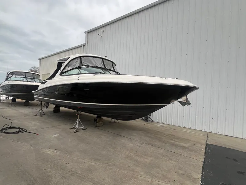 Slide: The Image of 2018 Sea Ray SLX 350 boat on stands near a white building. - 7