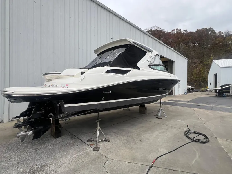 Slide: The Image of 2018 Sea Ray SLX 350 boat on stands near a warehouse. - 8
