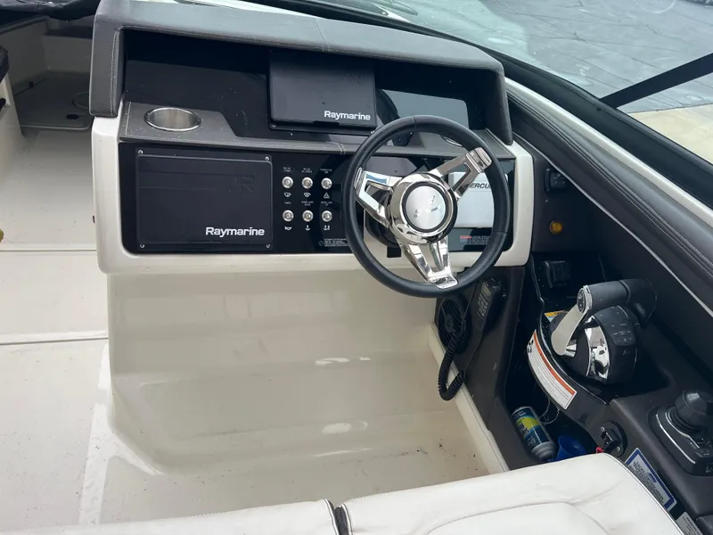 Slide: The Image of 2018 Sea Ray SLX 350 helm with Raymarine electronics and modern steering wheel. - 9