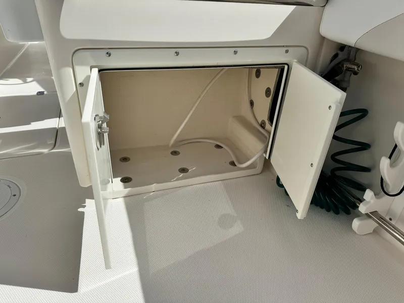 Slide: The Image of Open storage compartment on 2013 Edgewater 245 CX boat. - 15
