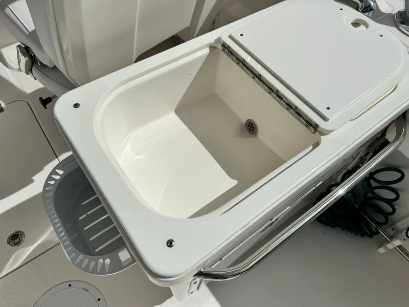 Slide: The Image of Edgewater 245 CX 2013 boat storage compartment with open lid. - 17