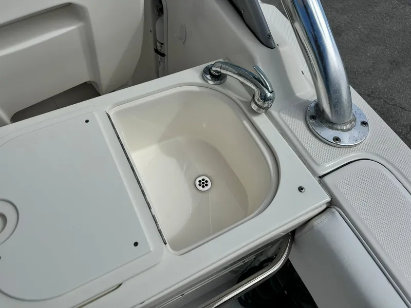 Slide: The Image of Edgewater 245 CX 2013 boat sink with faucet and drain. - 18