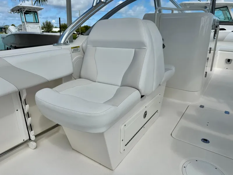 Slide: The Image of 2013 Edgewater 245 CX boat interior with white leather seating. - 19