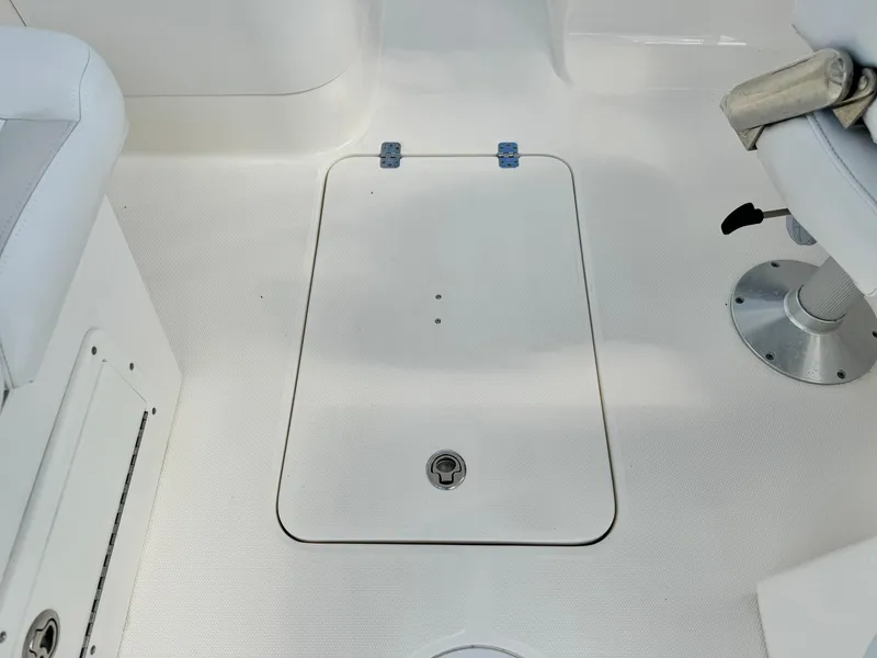 Slide: The Image of Edgewater 245 CX 2013 boat interior with storage hatch and seating. - 21