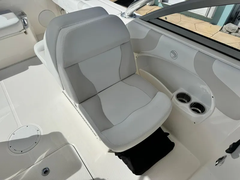 Slide: The Image of 2013 Edgewater 245 CX boat interior with white seating and cup holders. - 29