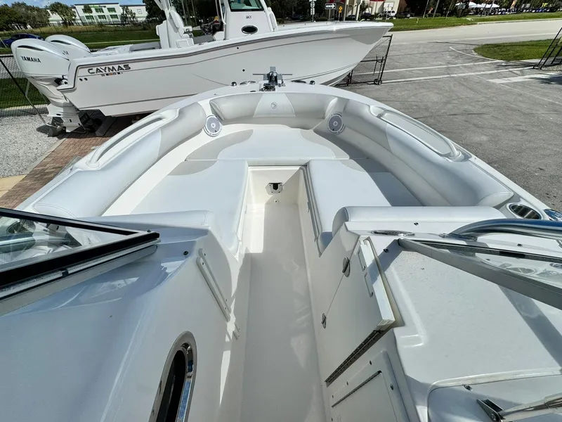 Slide: The Image of 2013 Edgewater 245 CX boat interior with spacious seating and storage compartments. - 30