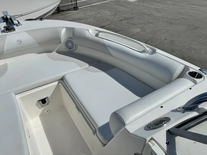 Slide: The Image of 2013 Edgewater 245 CX boat interior with white seating and cup holders. - 32