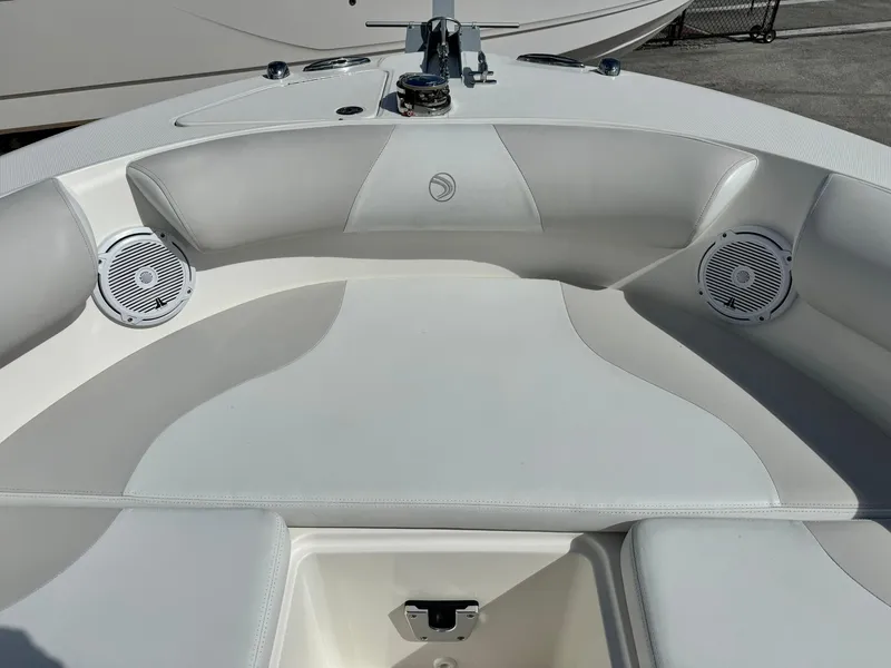Slide: The Image of 2013 Edgewater 245 CX boat interior with cushioned seating and built-in speakers. - 33