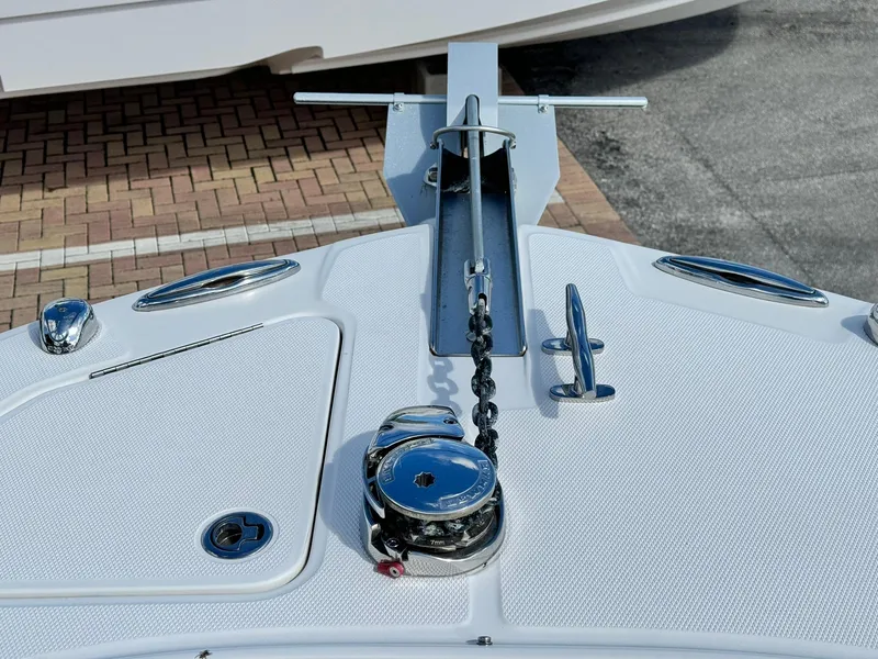 Slide: The Image of Anchor system on 2013 Edgewater 245 CX boat, featuring chrome details and chain mechanism. - 34