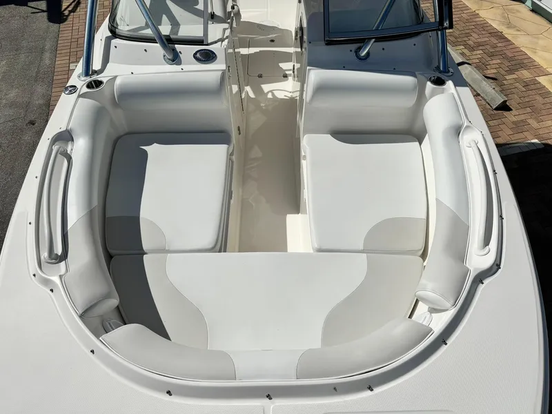 Slide: The Image of 2013 Edgewater 245 CX boat interior with white seating and dual consoles. - 35