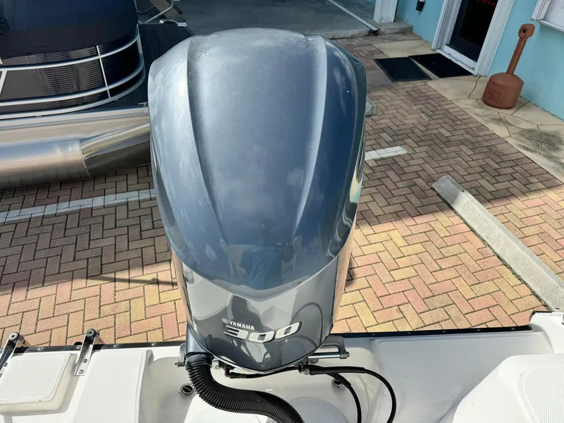 Slide: The Image of Yamaha 300 outboard motor on 2013 Edgewater 245 CX boat, parked on brick pavement. - 7