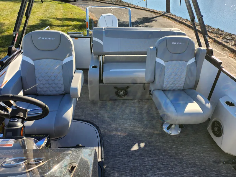 Slide: The Image of 2024 Crest Classic Platinum 220 boat interior with plush seating and modern design. - 11