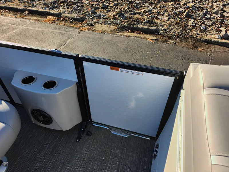 Slide: The Image of 2024 Crest Classic Platinum 220 boat interior with cup holders and seating. - 12