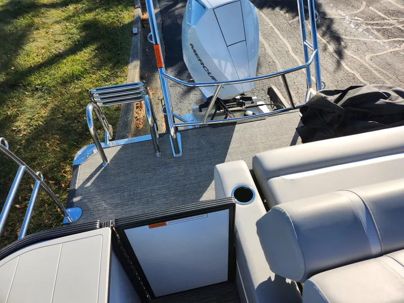 Slide: The Image of 2024 Crest Classic Platinum 220 boat interior with seating and motor view. - 14