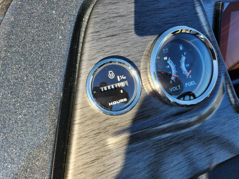 Slide: The Image of Dashboard of 2024 Crest Classic Platinum 220 with hour meter and volt/fuel gauges. - 15