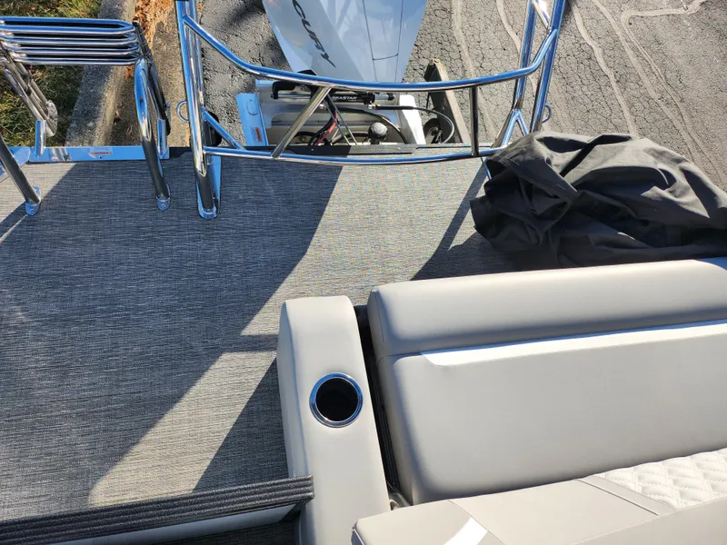 Slide: The Image of 2024 Crest Classic Platinum 220 boat deck with seating and cup holder. - 18