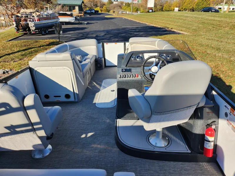 Slide: The Image of 2024 Crest Classic Platinum 220 boat interior with steering console and seating. - 19