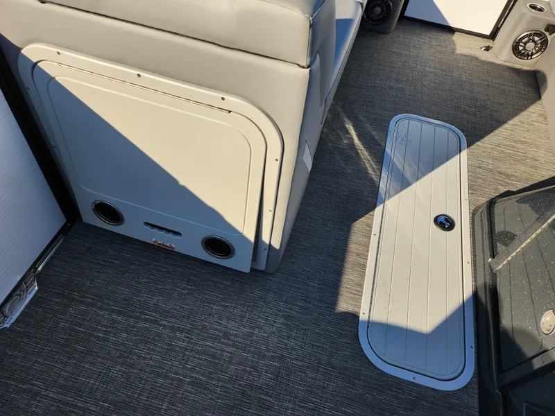 Slide: The Image of 2024 Crest Classic Platinum 220 boat interior with gray seating and flooring. - 22