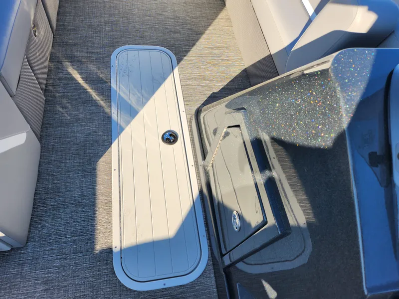 Slide: The Image of 2024 Crest Classic Platinum 220 boat interior with sleek flooring and modern design. - 23