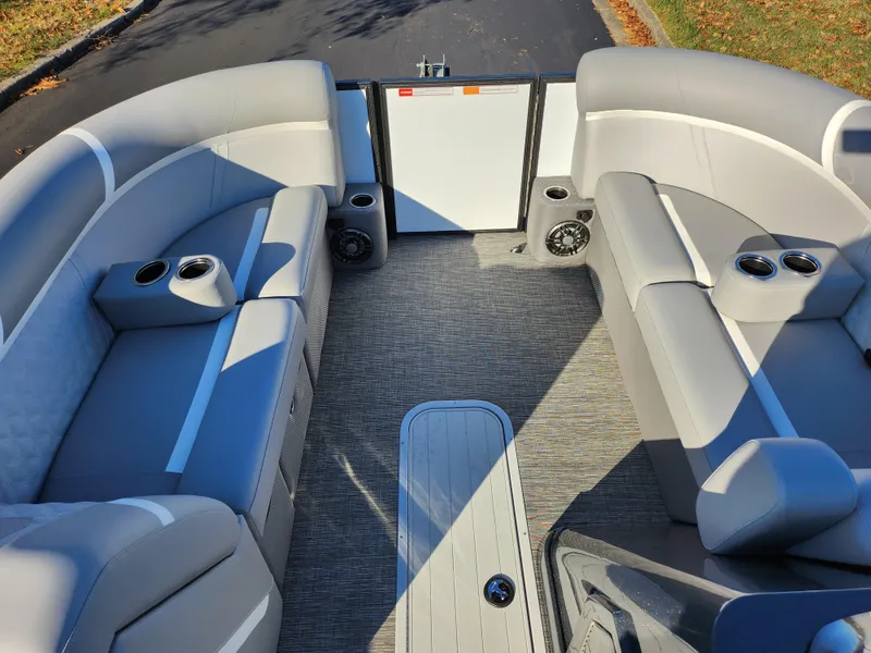 Slide: The Image of 2024 Crest Classic Platinum 220 boat interior with gray seating and cup holders. - 25