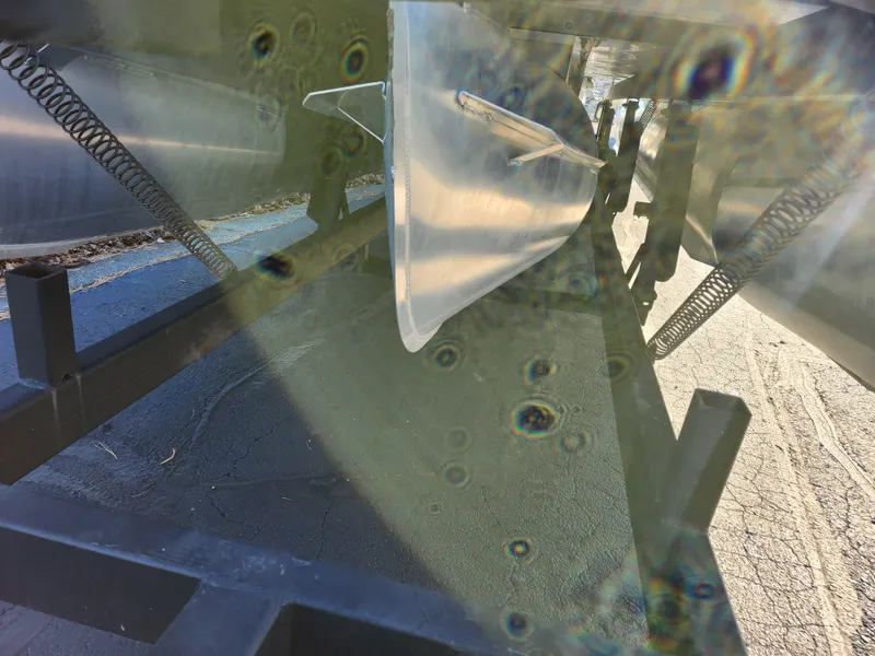 Slide: The Image of Close-up of 2024 Crest Classic Platinum 220 boat undercarriage with visible springs and metal components. - 7